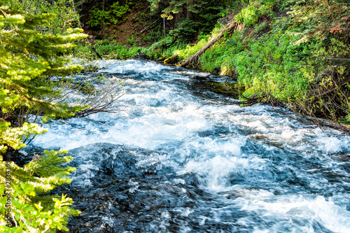 West Maroon creek river near bells lake at sunrise in Aspen, Colorado with closeup of raging water flowing in June 2019 summer photo
