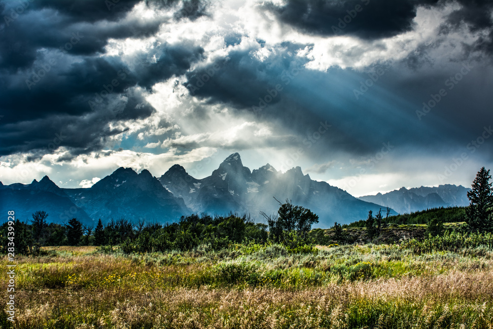 Fototapeta premium Sunbeams Cut Though the Clouds over the Tetons