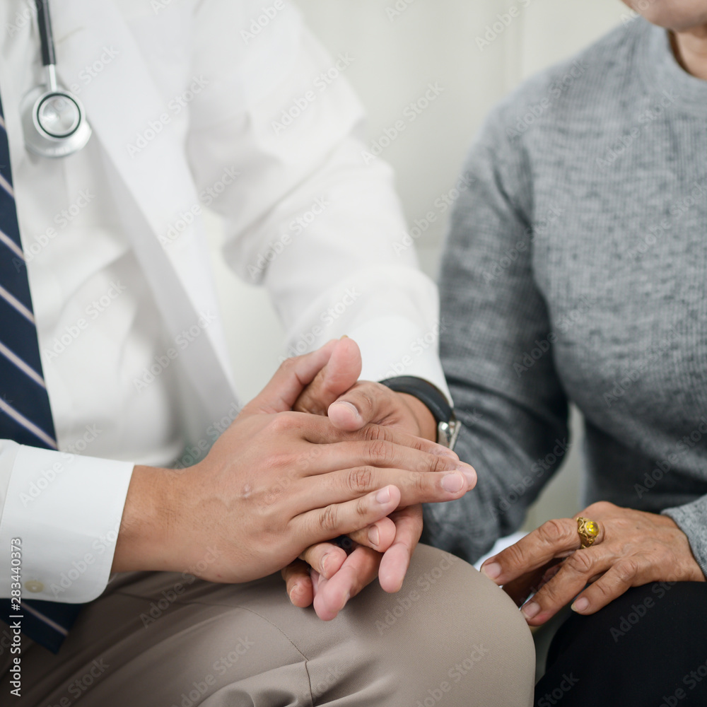 Dotocr and senior patiet holding hands together, trust and insurance concept. Dotocr and senior patiet holding hands together, trust and insurance concept.