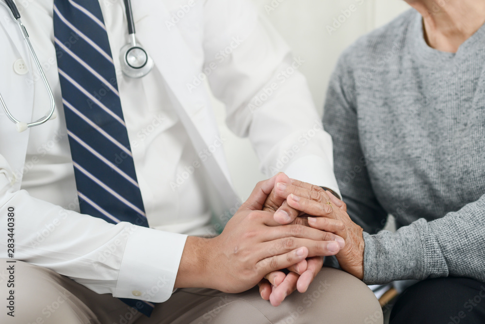 Dotocr and senior patiet holding hands together, trust and insurance concept. Dotocr and senior patiet holding hands together, trust and insurance concept.