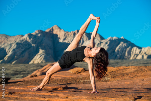 Woman in Yoga Pose with Sandstone Background