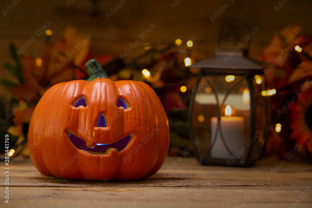 Halloween pumpkin head jack lantern on a wooden background with blurry lights, background for the holiday Halloween pumpkin head jack lantern on a wooden background with blurry lights, background for the holiday