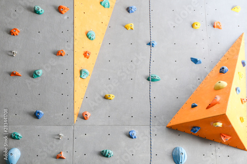 Wall with climbing holds in gym