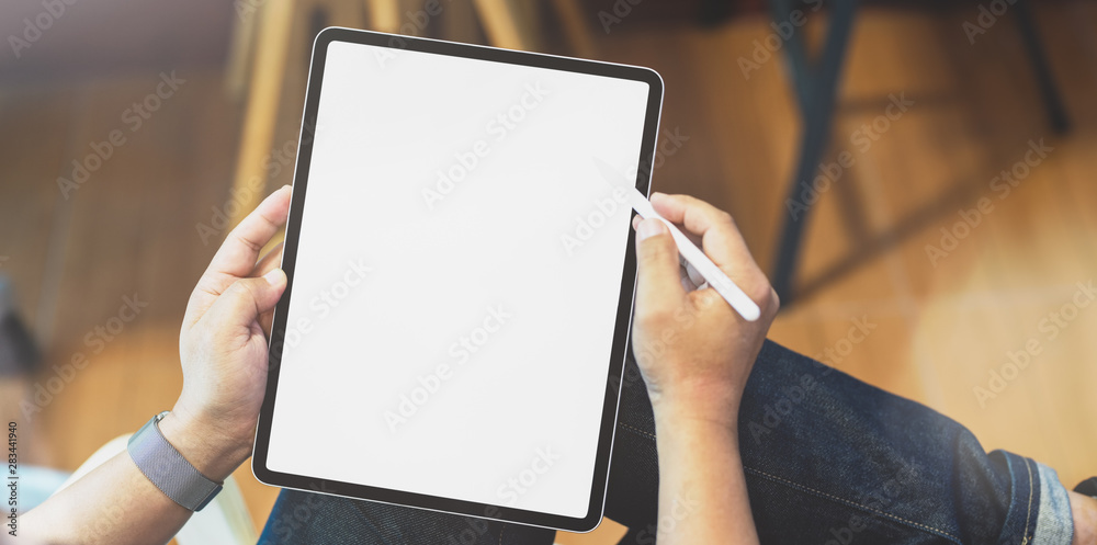 Professional freelancer editing his concept with blank screen tablet - obrazy, fototapety, plakaty 