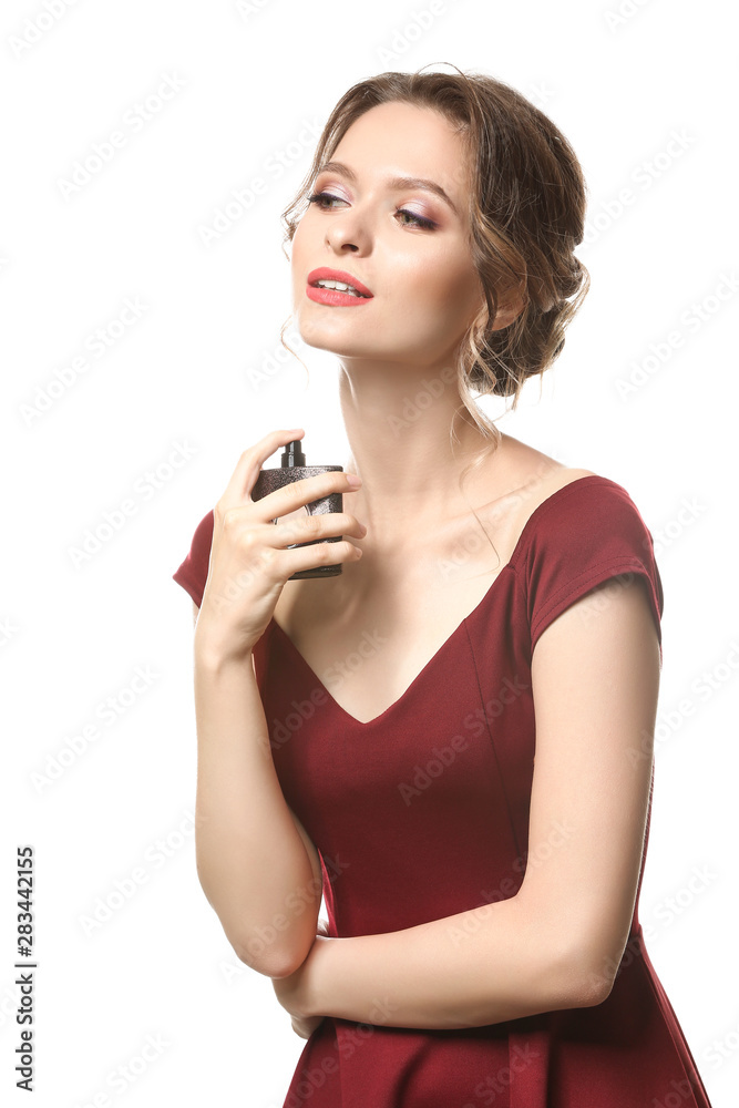 Beautiful young woman with bottle of perfume on white background Beautiful young woman with bottle of perfume on white background