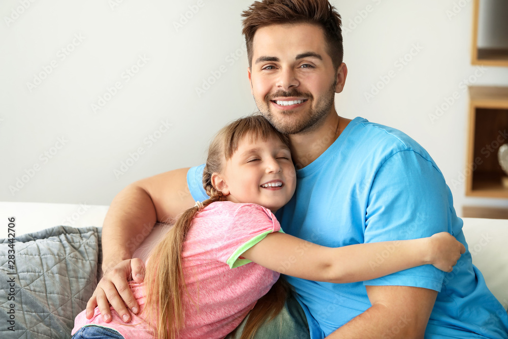 Portrait of happy father with daughter at home