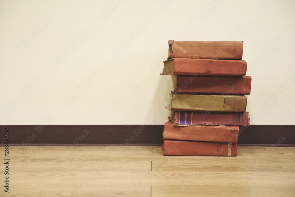 Old books on a wooden floor - Book stack in the library room for business and education wall background , back to school concept Old books on a wooden floor - Book stack in the library room for business and education wall background , back to school concept