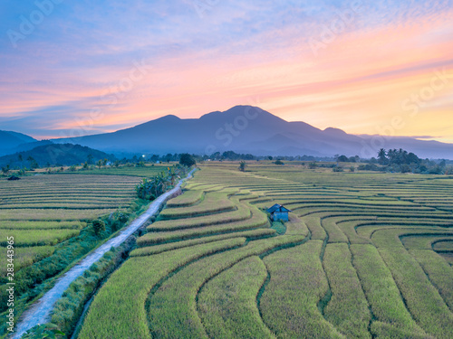 high mountain photos from the air where the red sky and sunrise are very beautiful and spoil the eyes above yellow rice fields in bengkulu, indonesia, asia