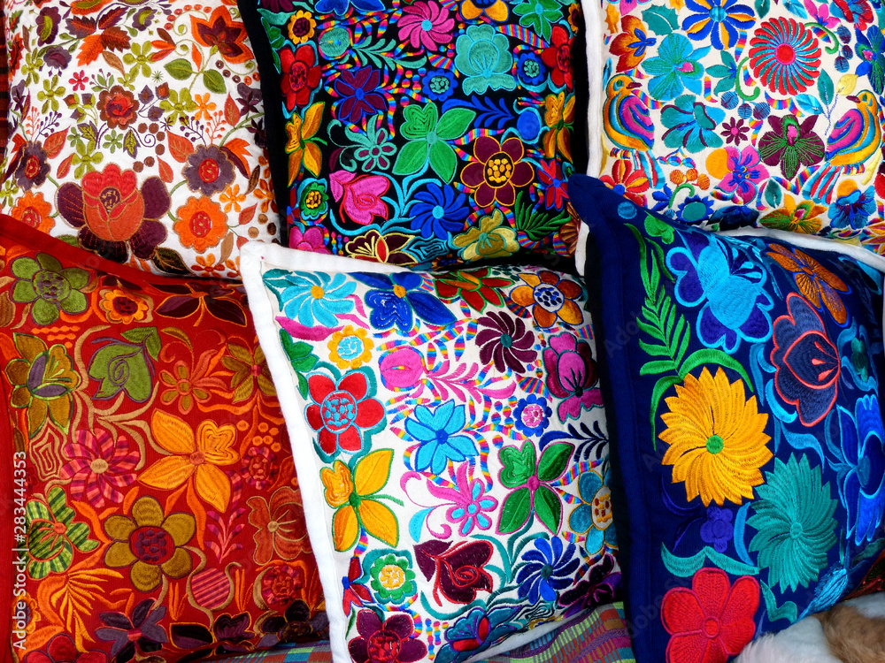 Close up of сolorful embroidered decorative pillows and textiles at the artisan's market in Otavalo, Ecuador