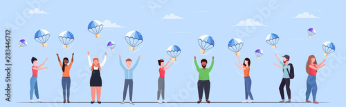 people catching parcel boxes falling down with parachute from sky transportation shipping package air mail express postal delivery concept full length flat horizontal