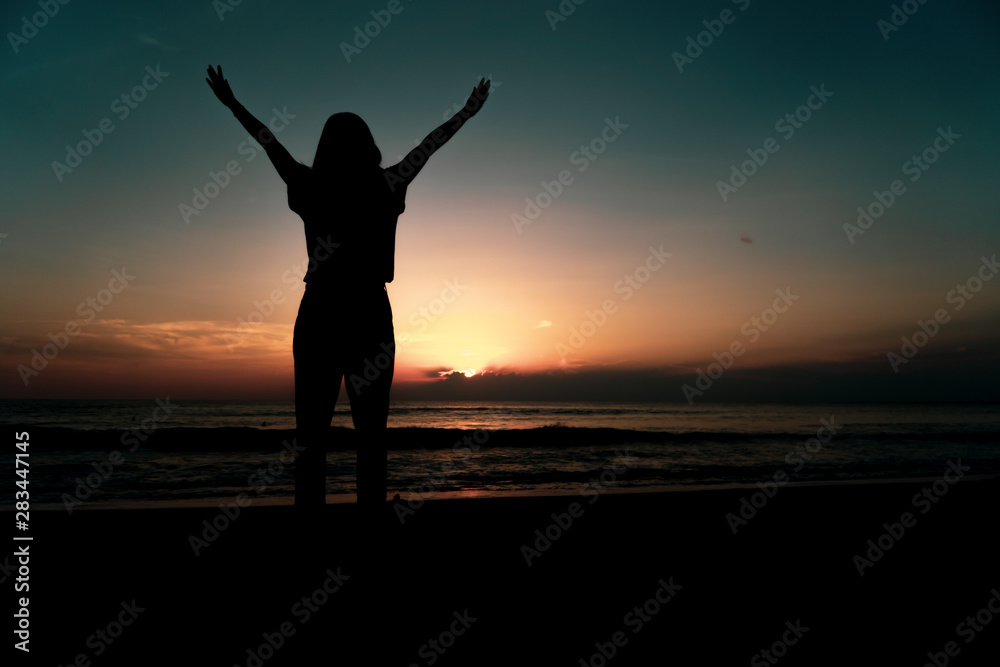 Woman rise hands up to sky freedom concept with blue sky.