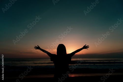 Woman rise hands up to sky freedom concept with blue sky.