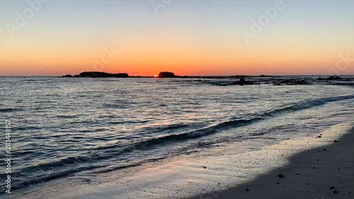 Timelapse nature video of birds soaring the twilight sky on the beach. photo