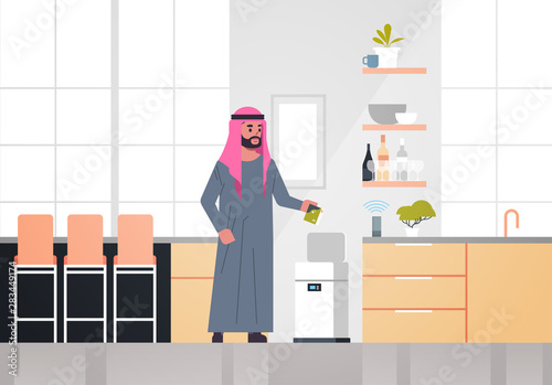 arab man putting trash in electronic recycling bin controlled by smart speaker voice recognition activated digital assistant concept modern kitchen interior horizontal full length