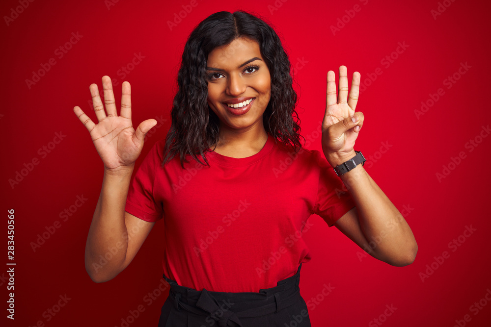 Beautiful transsexual transgender woman wearing t-shirt over isolated red background showing and pointing up with fingers number eight while smiling confident and happy. Beautiful transsexual transgender woman wearing t-shirt over isolated red background showing and pointing up with fingers number eight while smiling confident and happy.