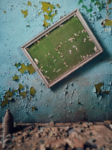 old plaque on the wall in an abandoned factory . cracked paint texture photo