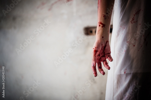 Close up the hands of young woman evil nightmare behind a horrible fear in halloween night.