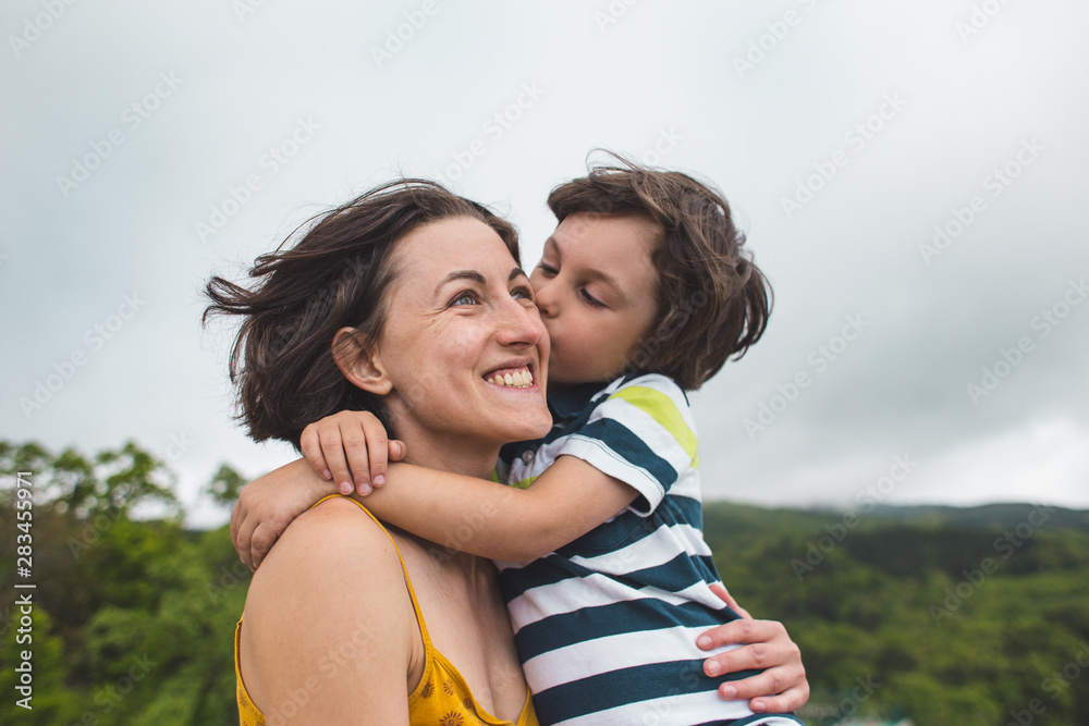 The boy hugs mom. The boy hugs mom.