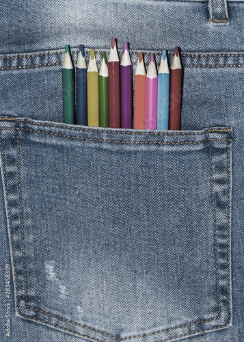 colored pencils are in the pocket of jeans