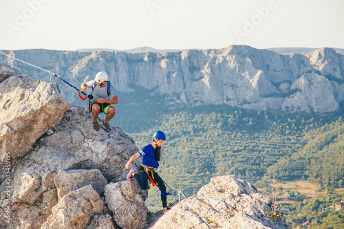 Man and Woman climbing mountain. 