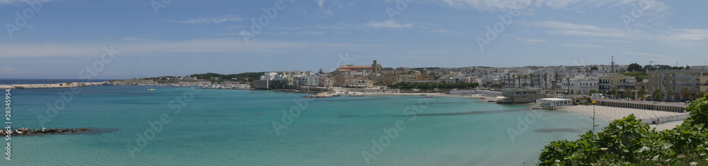 Otranto panorama of the beach and of the southern promenade. Otranto sandy beach and its white southern promenade are located on the Adriatic coast of Salento, Italy.