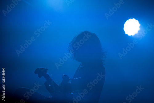 Silhouette of a guitarist on the stage