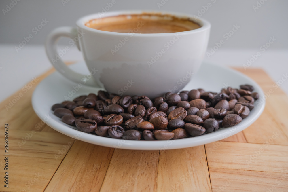 white cup and coffee bean on wood block white cup and coffee bean on wood block