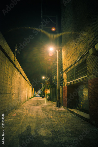 Dark and eerie urban city alley at night 