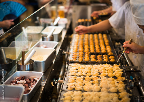 Japanese snack food “Takoyaki” shop at local market in japan