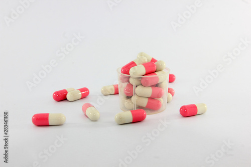 Pink and white capsules on white background. Antimicrobial capsule pills, Pharmacy. 