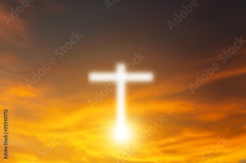 Conceptual wood cross or religion symbol shape over a sunset sky with clouds background for God. belief or resurrection of god and worship christian. sky freedom. © Love You Stock