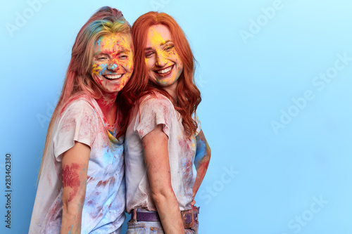 national, family celebration, two awesome happy friends take part in the smearing of colours. close up portrait. copy space