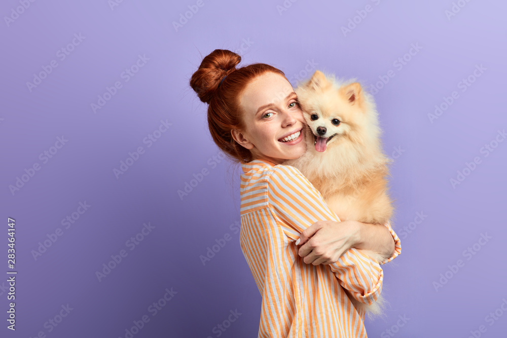 beautiful girl cannot imagine her life without her pet. close up portrait, isolated blue background, studio shot - obrazy, fototapety, plakaty 
