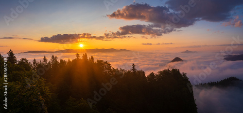 beautiful, spectacular sunrise above the clouds at the top of Three Crowns-Pieniny, Poland © Mike Mareen