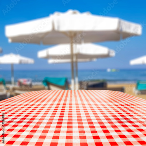Table background and beach on sunny day in distance. Empty space for products and decoration. © magdal3na