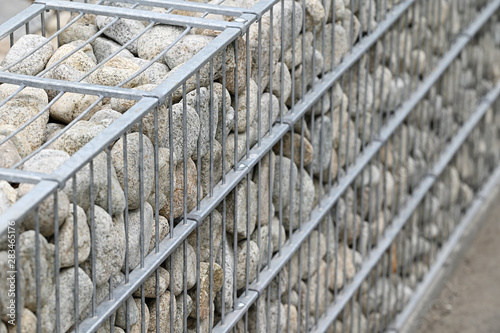 Decorative stones stored in the frame for a low wall.