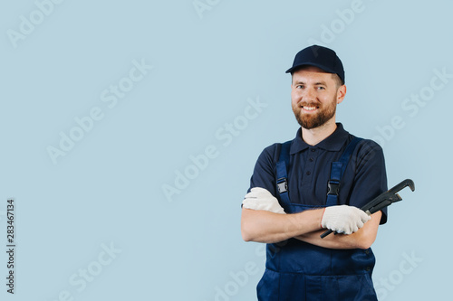 Portrait of a happy service worker with hands crossed, dressed in uniform photo