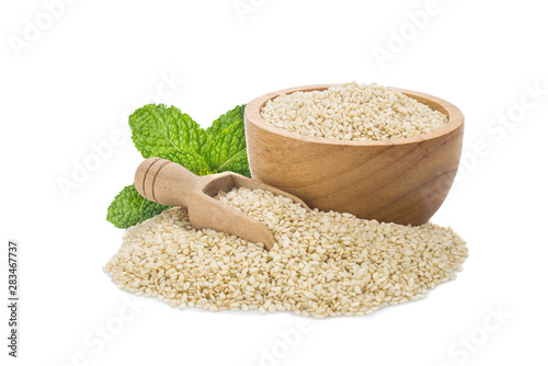 White Sesame seeds in wooden bowl and spoon isolated on white background.Organic natural sesame seeds and extract oil concept