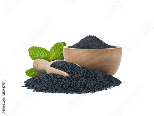 Black Sesame seeds in wooden bowl and spoon isolated on white background.Organic natural sesame seeds and extract oil concept