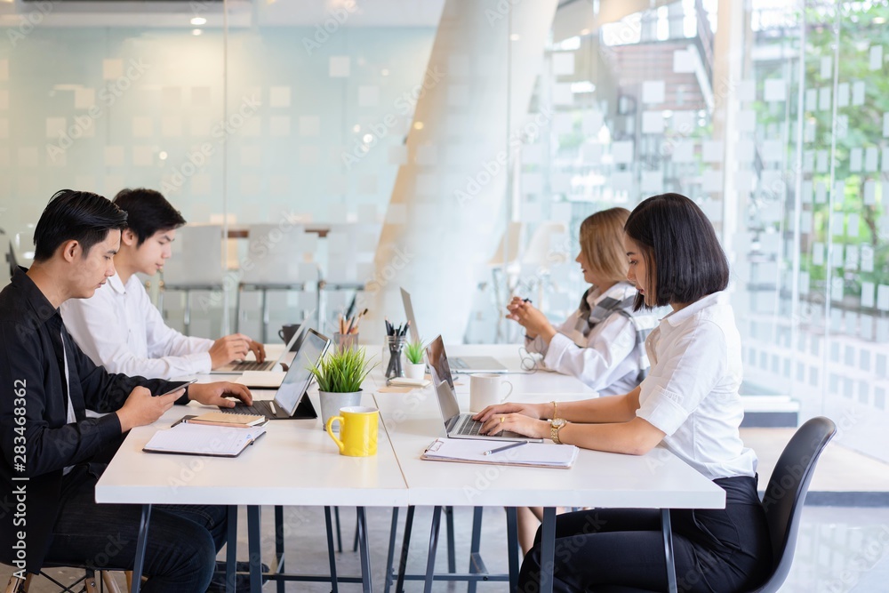 group of asian diverse university students concentrated on study or working together with laptop at a university. indoor group of asian diverse university students concentrated on study or working together with laptop at a university. indoor