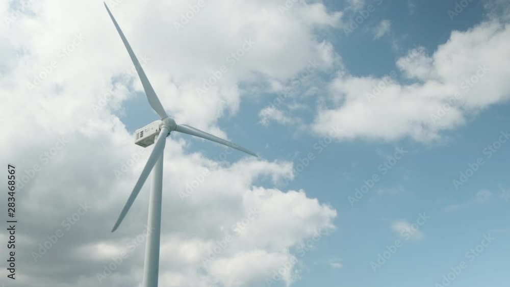 Wind turbines are running against a blue sky and clouds. Wind turbines are running against a blue sky and clouds.