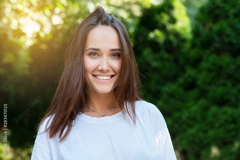 Portrait of beautiful young girl posing in summer park. Majestic woman's beauty. Youth, happiness, lifestyle. Portrait of beautiful young girl posing in summer park. Majestic woman's beauty. Youth, happiness, lifestyle.