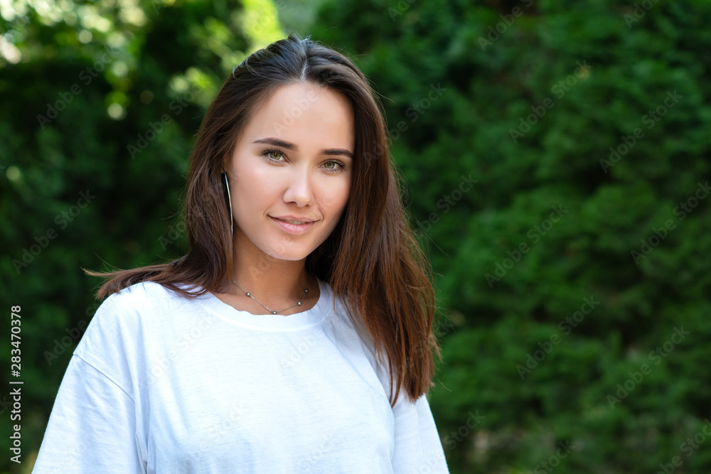 Portrait of beautiful young girl posing in summer park. Majestic woman's beauty. Youth, happiness, lifestyle. Portrait of beautiful young girl posing in summer park. Majestic woman's beauty. Youth, happiness, lifestyle.