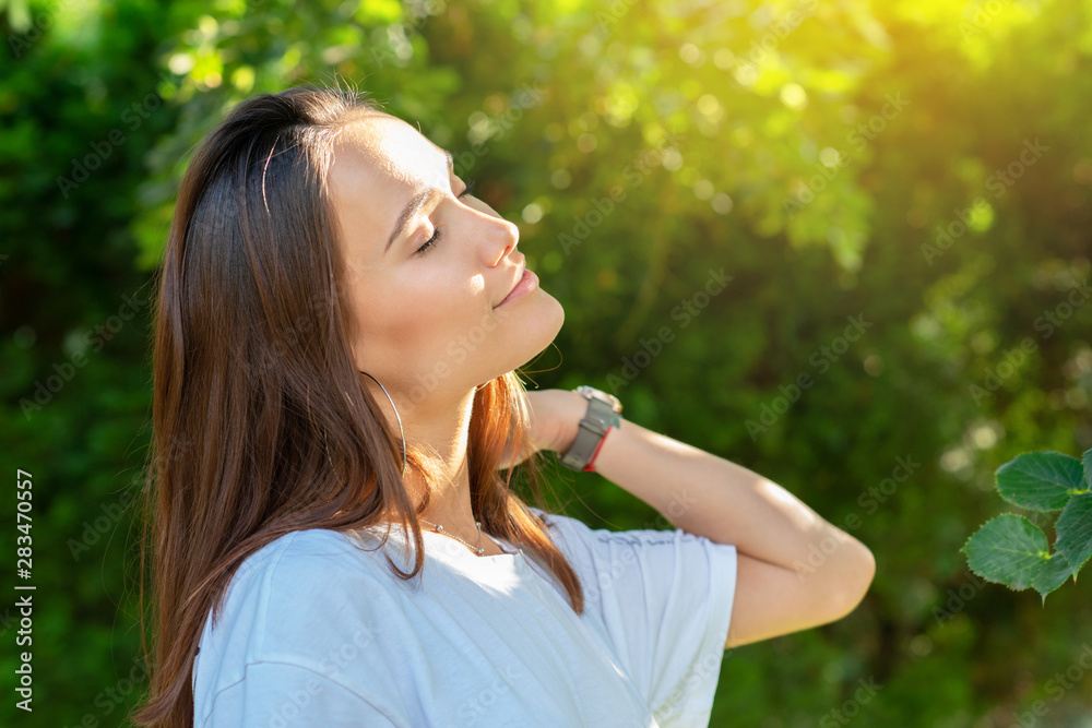 Portrait of beautiful young girl posing in summer park. Majestic woman's beauty. Youth, happiness, lifestyle. Portrait of beautiful young girl posing in summer park. Majestic woman's beauty. Youth, happiness, lifestyle.
