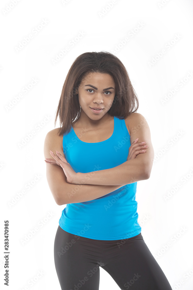 Healthy and Fitness concept - beautiful African American girl in sport clothes after workout. Isolated on white studio background. Healthy and Fitness concept - beautiful African American girl in sport clothes after workout. Isolated on white studio background.