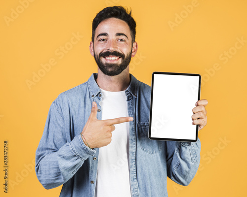 Medium shot guy pointing at a tablet