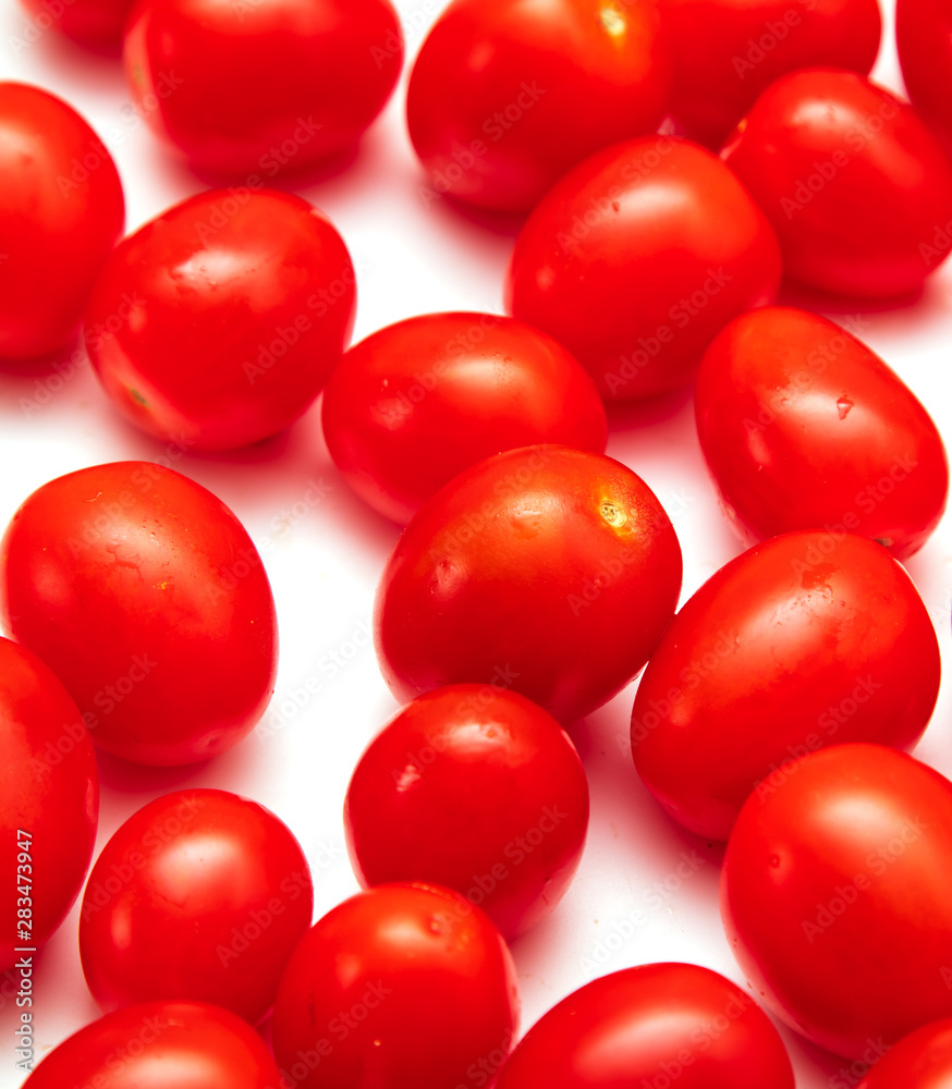 Red cherry tomatoes on a white background Red cherry tomatoes on a white background