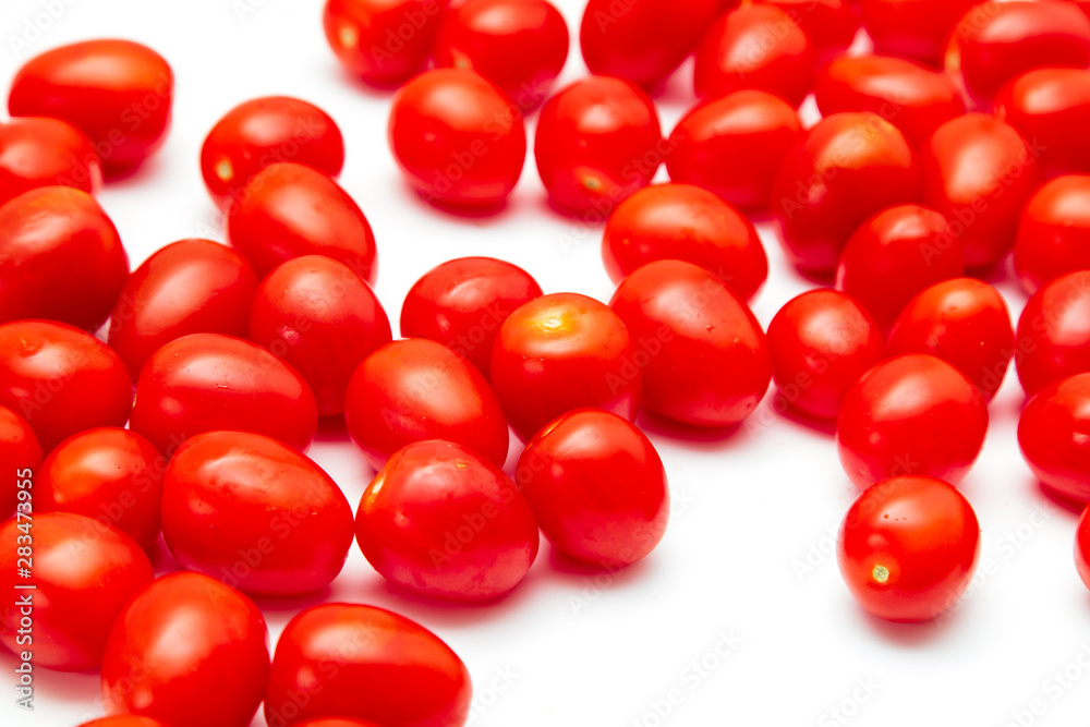 Red cherry tomatoes on a white background Red cherry tomatoes on a white background