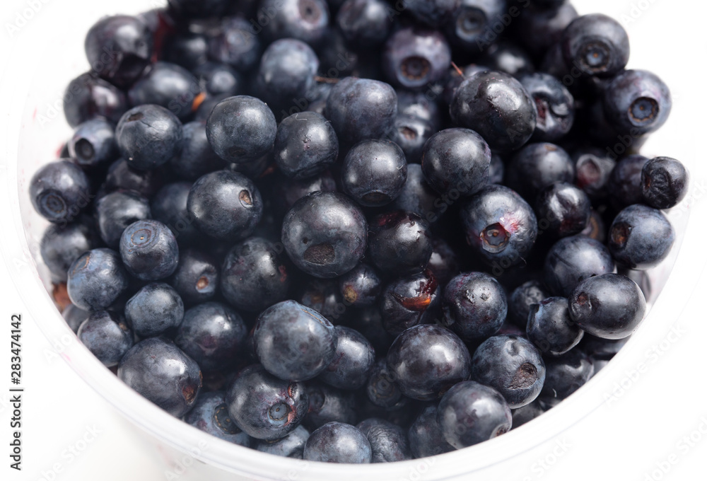 Blueberries in a glass on a white background Blueberries in a glass on a white background