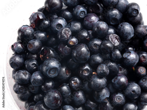 Blueberries in a glass on a white background